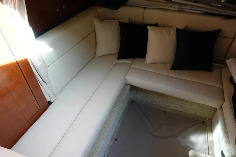 Slide: The Image of Interior of 2007 Sea Ray 320 Sundancer with white seating and black cushions. - 25