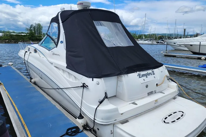 Slide: The Image of 2007 Sea Ray 320 Sundancer docked at marina with black canopy. - 3