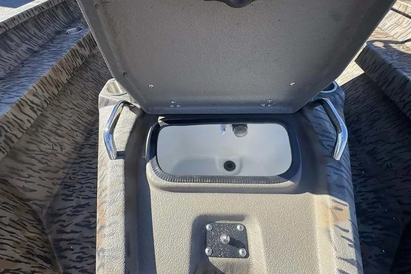 Slide: The Image of Open storage compartment in 2026 Xpress H20B Bay boat, featuring camo interior design. - 11