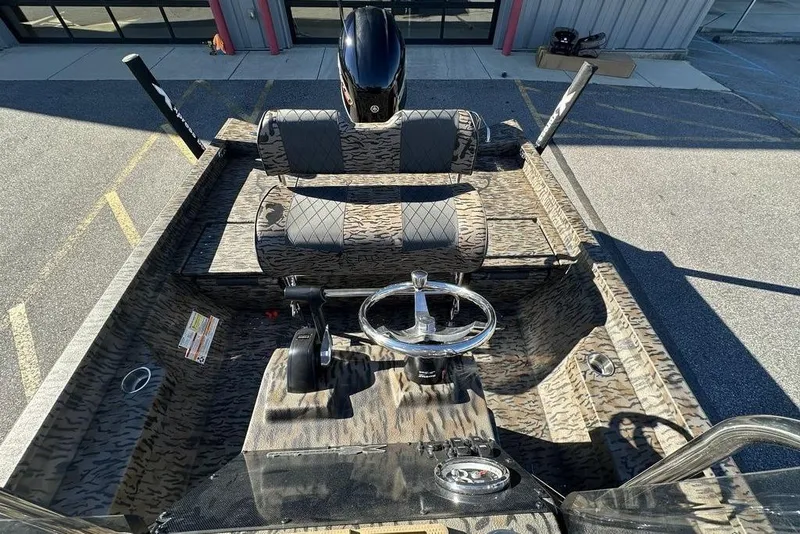 Slide: The Image of 2026 Xpress H20B Bay boat interior with camouflage design and steering wheel. - 12