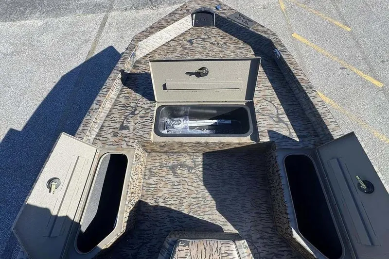 Slide: The Image of 2026 Xpress H20B Bay boat with open storage compartments, camo pattern design. - 14