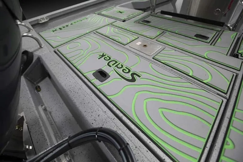 Slide: The Image of 2026 Xpress H20B Bay boat deck with green SeaDek pattern. - 18