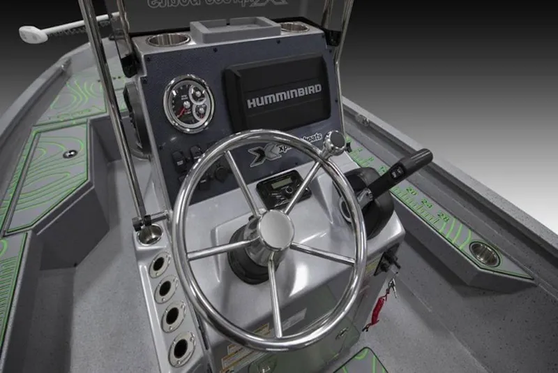 Slide: The Image of 2026 Xpress H20B Bay boat dashboard with steering wheel and Humminbird electronics. - 20