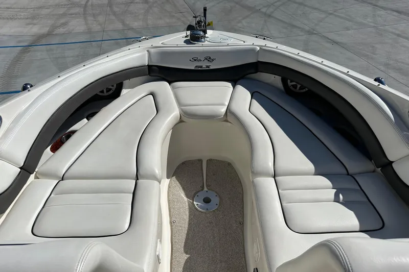 Slide: The Image of 2007 Sea Ray 290 SLX boat interior with white leather seating and sleek design. - 18