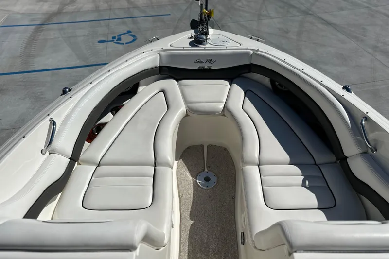Slide: The Image of 2007 Sea Ray 290 SLX boat interior with white cushioned seating and sleek design. - 19