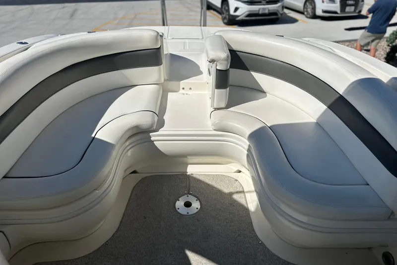 Slide: The Image of 2007 Sea Ray 290 SLX boat interior with curved seating and carpeted floor. - 23
