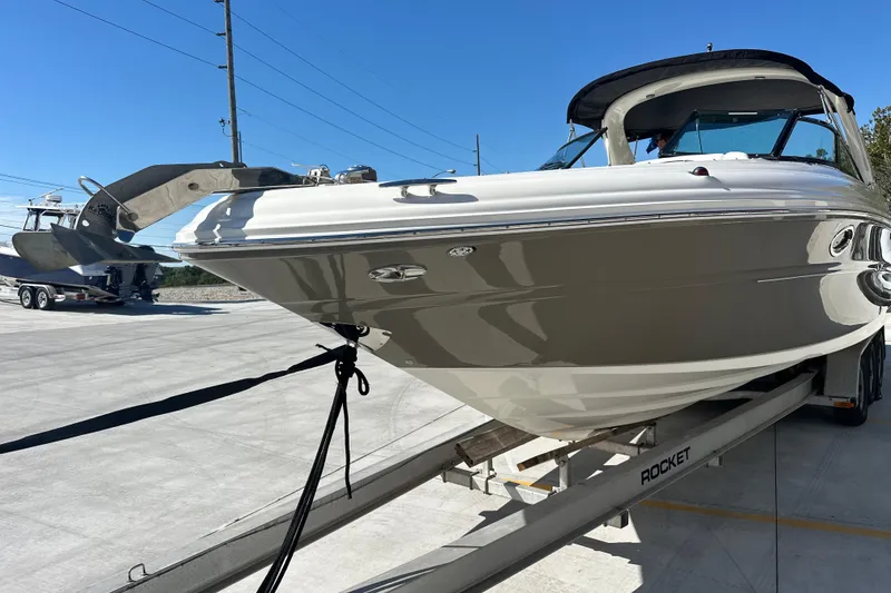 Slide: The Image of 2007 Sea Ray 290 SLX boat on trailer under clear blue sky. - 3