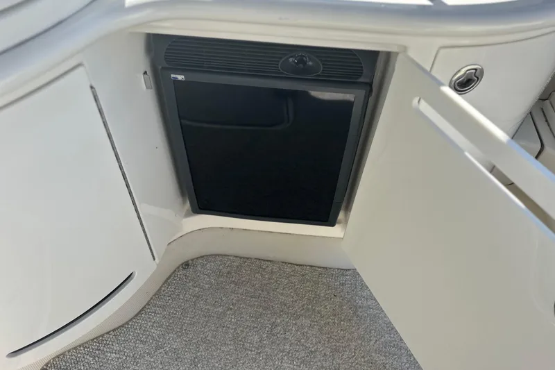 Slide: The Image of 2007 Sea Ray 290 SLX boat interior with open cabinet and mini fridge. - 41