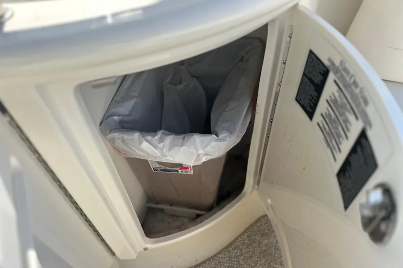 Slide: The Image of Trash bin inside a 2007 Sea Ray 290 SLX boat compartment. - 42