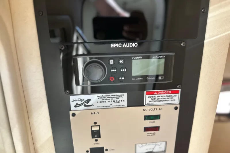 Slide: The Image of Control panel of a 2007 Sea Ray 290 SLX boat with audio system and safety warnings. - 46