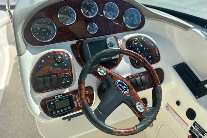 Slide: The Image of 2007 Sea Ray 290 SLX dashboard with wood accents and modern controls. - 49