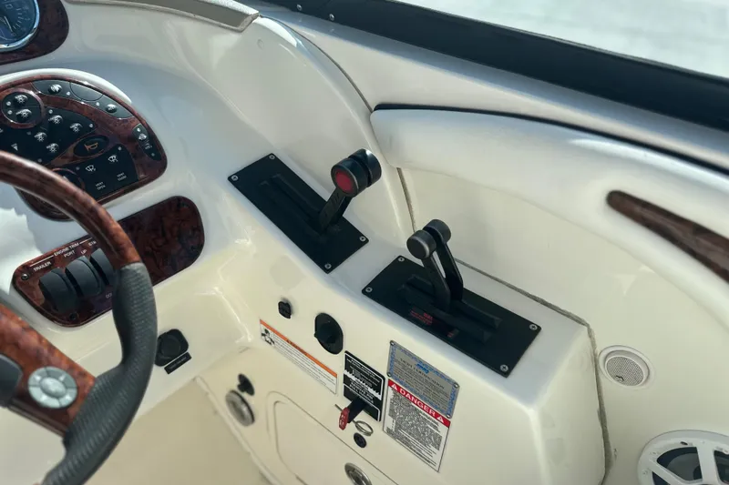 Slide: The Image of 2007 Sea Ray 290 SLX boat controls and dashboard with wood accents. - 50
