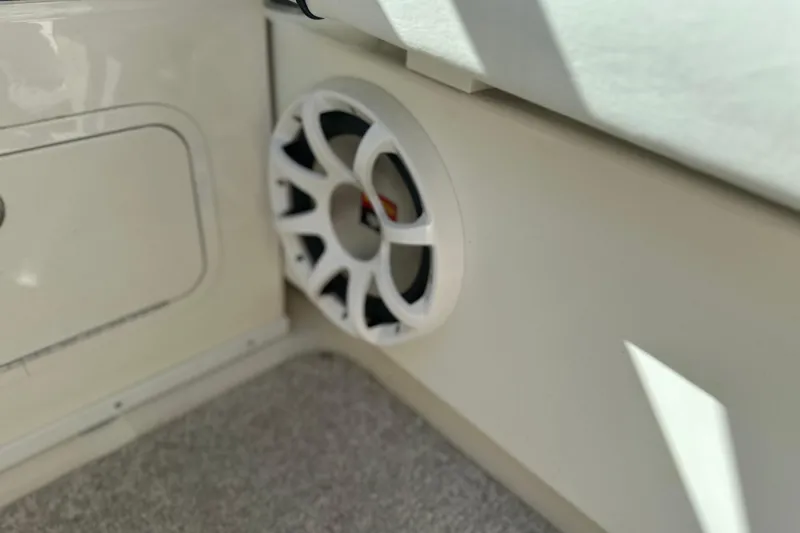 Slide: The Image of Speaker on 2007 Sea Ray 290 SLX boat interior, featuring white paneling and carpet. - 52
