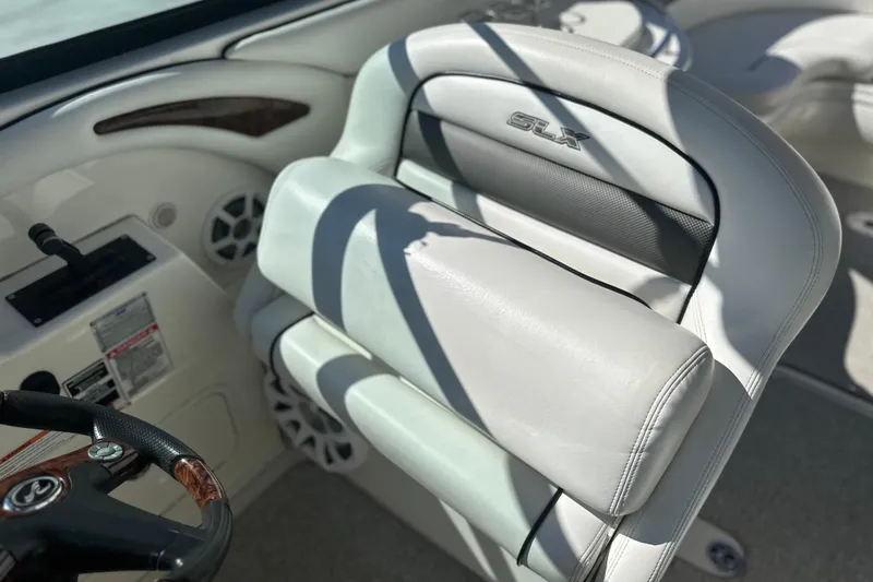 Slide: The Image of 2007 Sea Ray 290 SLX boat interior with white leather seating and steering wheel. - 53