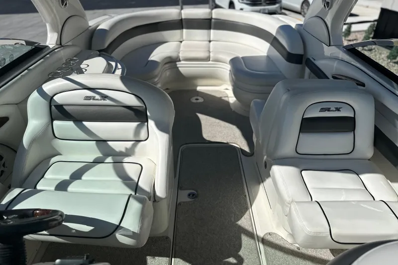 Slide: The Image of Interior of a 2007 Sea Ray 290 SLX boat with white leather seating. - 54