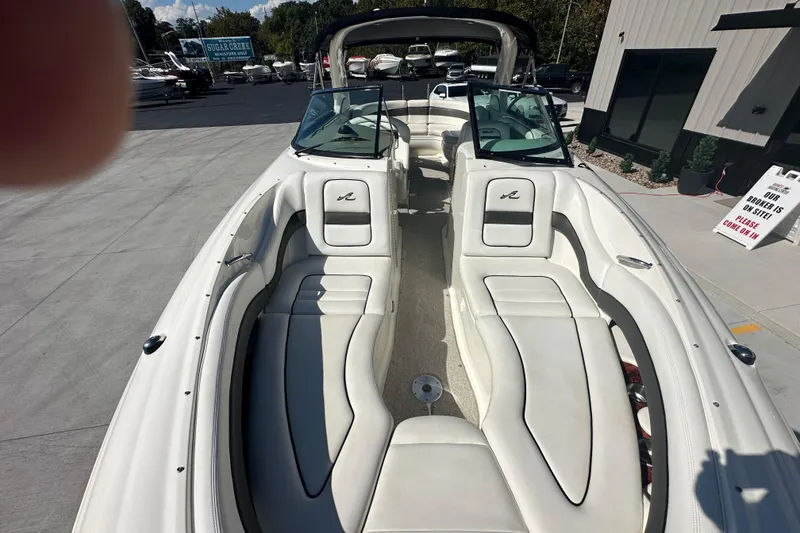 Slide: The Image of 2007 Sea Ray 290 SLX boat with spacious seating and sleek design at a marina. - 56