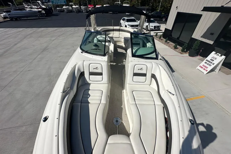 Slide: The Image of 2007 Sea Ray 290 SLX boat with white interior, docked at a marina. - 57