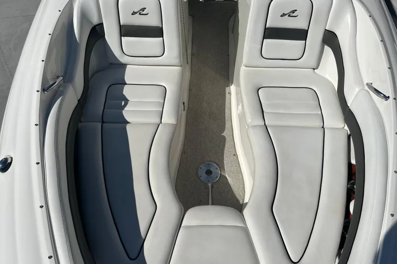 Slide: The Image of 2007 Sea Ray 290 SLX boat interior with white cushioned seating and sleek design. - 58