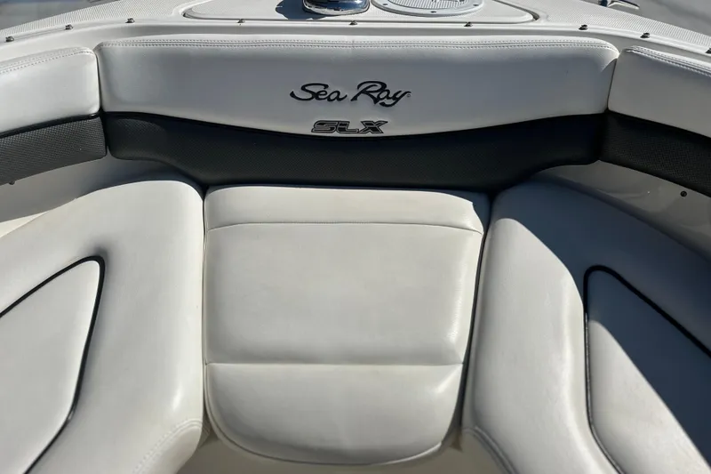 Slide: The Image of 2007 Sea Ray 290 SLX boat interior with white leather seating and logo. - 60