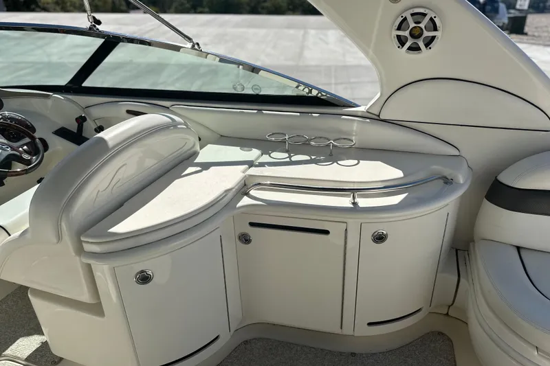 Slide: The Image of 2007 Sea Ray 290 SLX boat interior with sleek white seating and dashboard. - 67