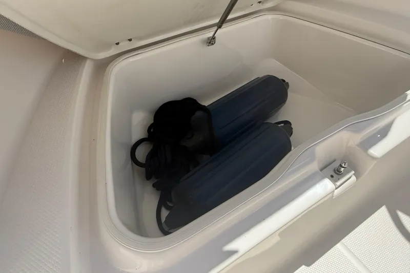 Slide: The Image of Storage compartment in 2020 Robalo R180 Center Console boat with fenders inside. - 10