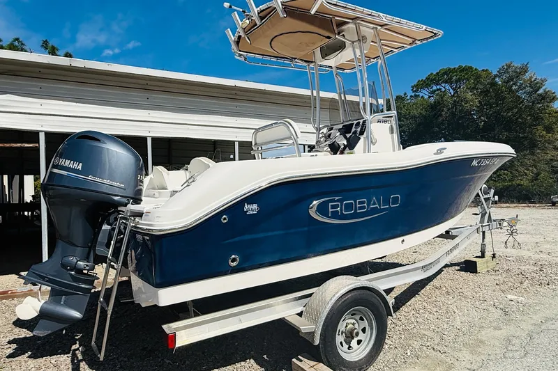 Slide: The Image of 2020 Robalo R180 Center Console boat on trailer with Yamaha outboard motor. - 2