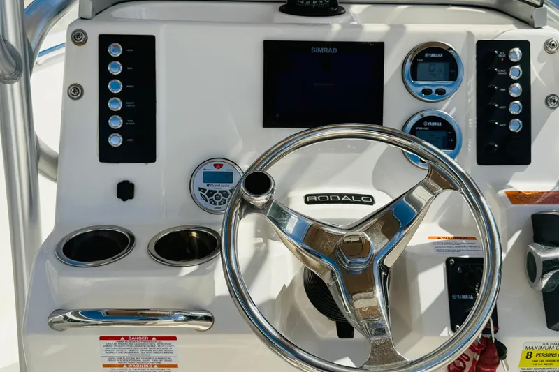 Slide: The Image of 2020 Robalo R180 Center Console dashboard with steering wheel and control panel. - 3