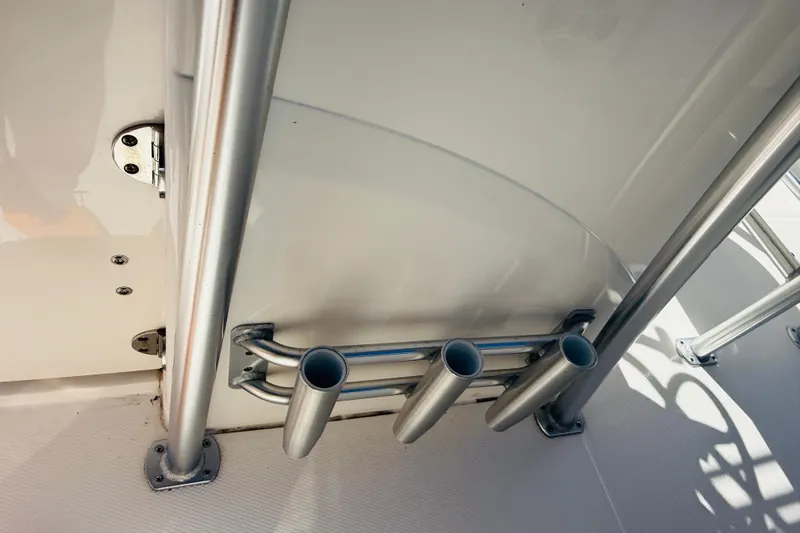 Slide: The Image of 2020 Robalo R180 Center Console boat rod holders and stainless steel railing. - 9