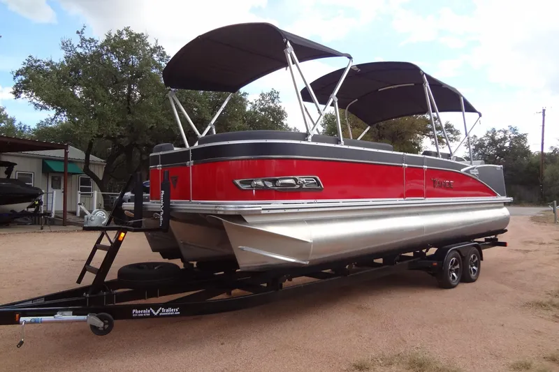 The Image of 2024 Tahoe Pontoon 2585 VRL boat on trailer, featuring red and silver design. - 1