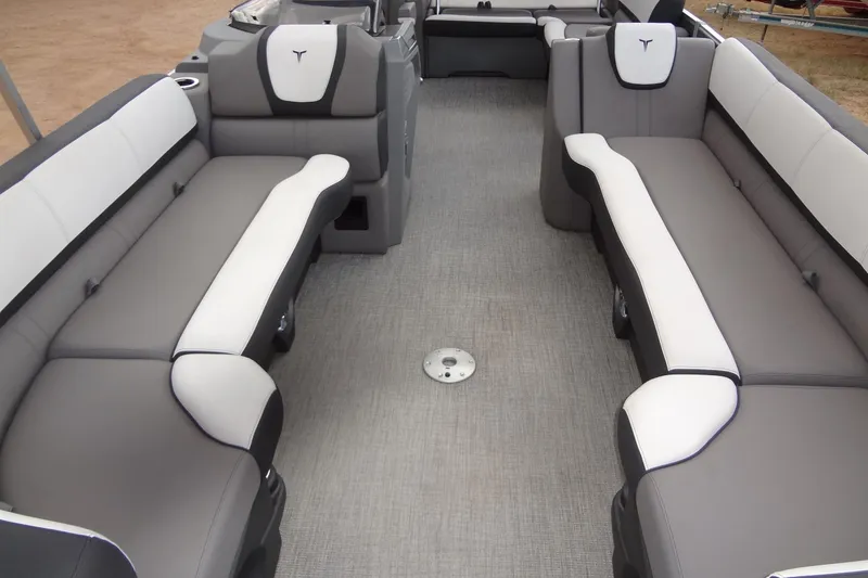 Slide: The Image of 2024 Tahoe Pontoon 2585 VRL interior with gray and white seating, spacious layout. - 10