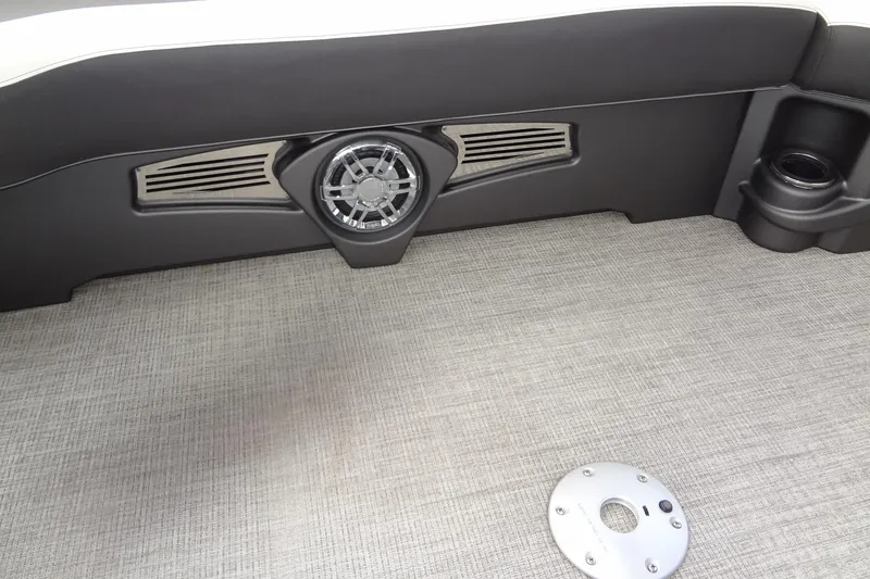 Slide: The Image of 2024 Tahoe Pontoon 2585 VRL interior with speaker and cup holder on textured flooring. - 15