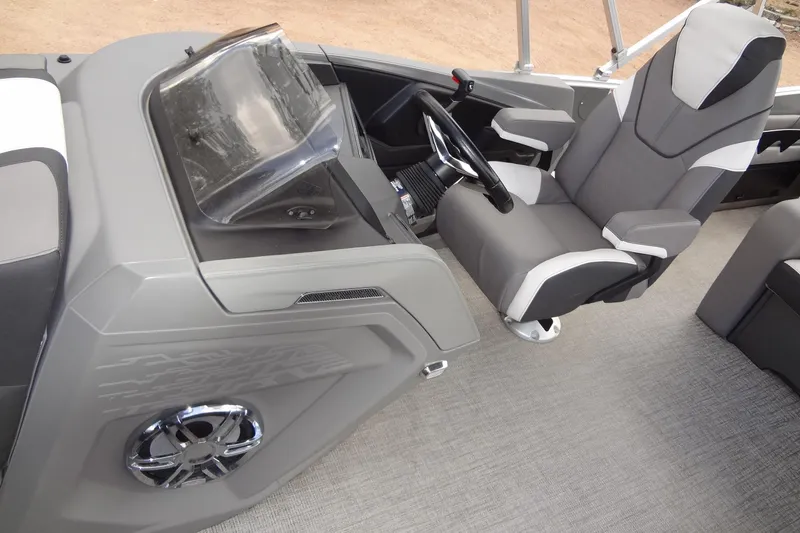 Slide: The Image of 2024 Tahoe Pontoon 2585 VRL cockpit with modern steering and comfortable seating. - 22