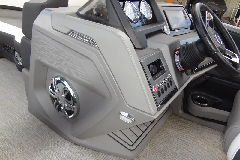 Slide: The Image of 2024 Tahoe Pontoon 2585 VRL dashboard with steering wheel and control panel. - 23