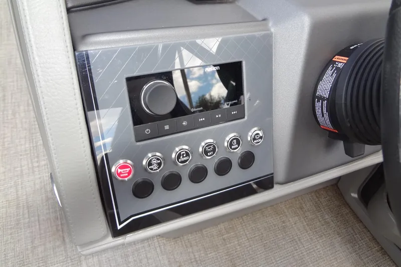 Slide: The Image of 2024 Tahoe Pontoon 2585 VRL dashboard with control panel and stereo system. - 26