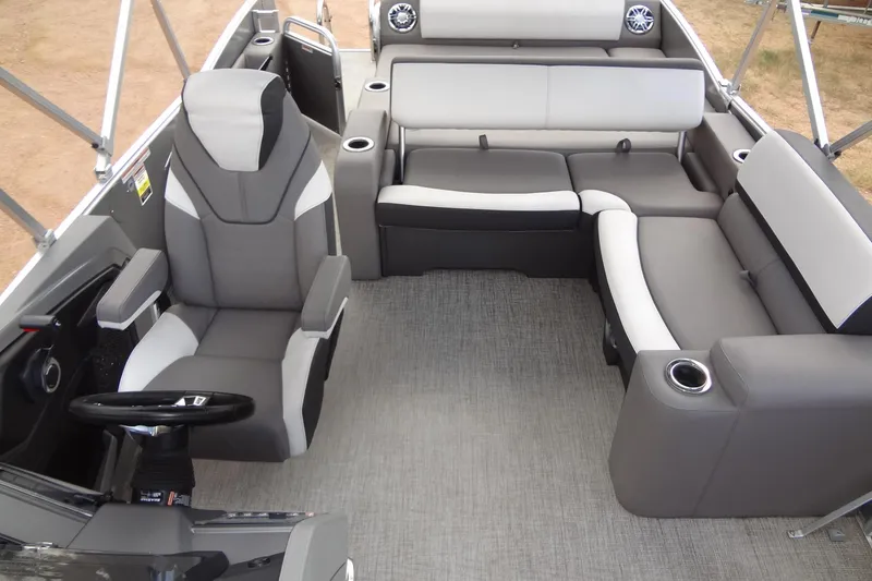 Slide: The Image of 2024 Tahoe Pontoon 2585 VRL interior with gray seating and modern helm. - 29
