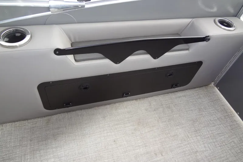 Slide: The Image of 2024 Tahoe Pontoon 2585 VRL interior with cup holders and storage compartment. - 35
