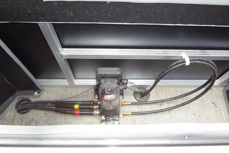 Slide: The Image of 2024 Tahoe Pontoon 2585 VRL hydraulic system with hoses and pump. - 38