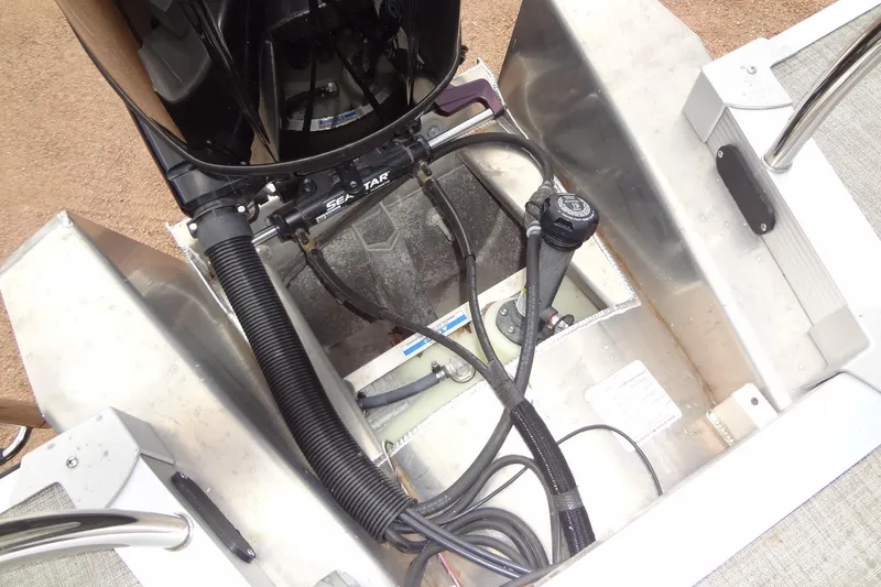 Slide: The Image of 2024 Tahoe Pontoon 2585 VRL engine compartment with visible cables and components. - 39