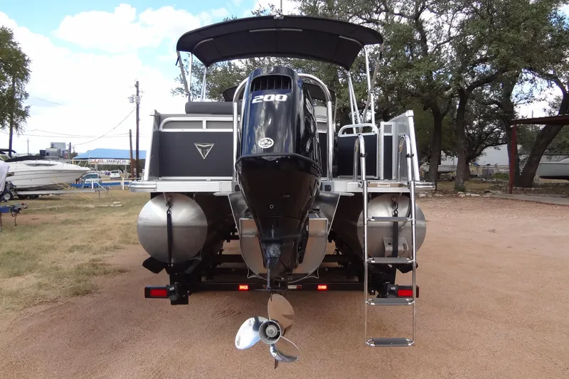 Slide: The Image of 2024 Tahoe Pontoon 2585 VRL with powerful outboard motor and sleek design. - 4