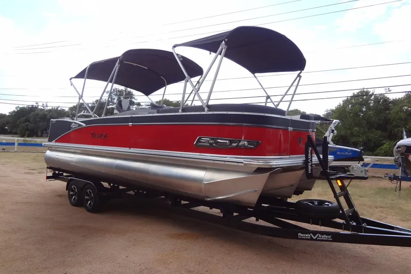 Slide: The Image of 2024 Tahoe Pontoon 2585 VRL boat with red exterior on a trailer. - 7