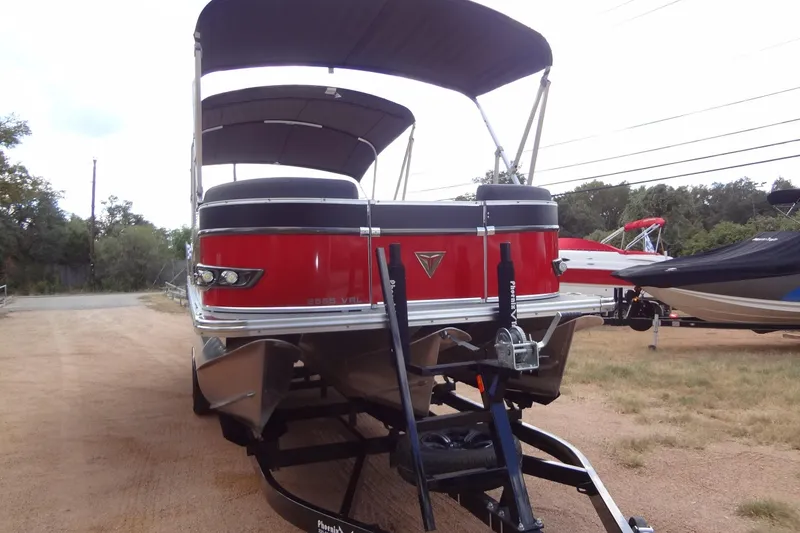 Slide: The Image of 2024 Tahoe Pontoon 2585 VRL boat on trailer, featuring red and black design. - 8