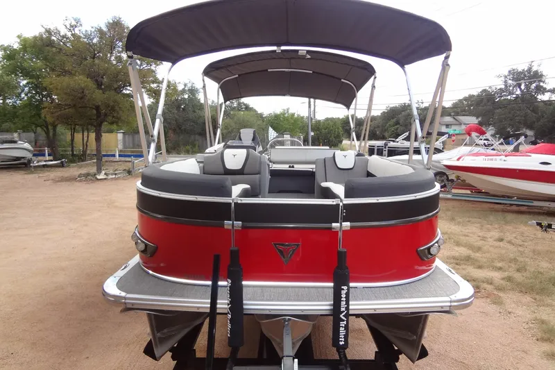Slide: The Image of 2024 Tahoe Pontoon 2585 VRL, red exterior, parked on a trailer, with canopy and seating. - 9