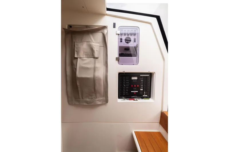 Slide: The Image of Interior control panel of 2005 Wally Yachts Tender Express, featuring navigation and electrical systems. - 13