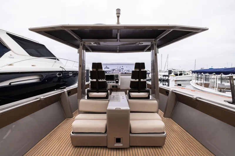 Slide: The Image of 2005 Wally Yachts Tender Express with sleek seating and modern design at a marina. - 5