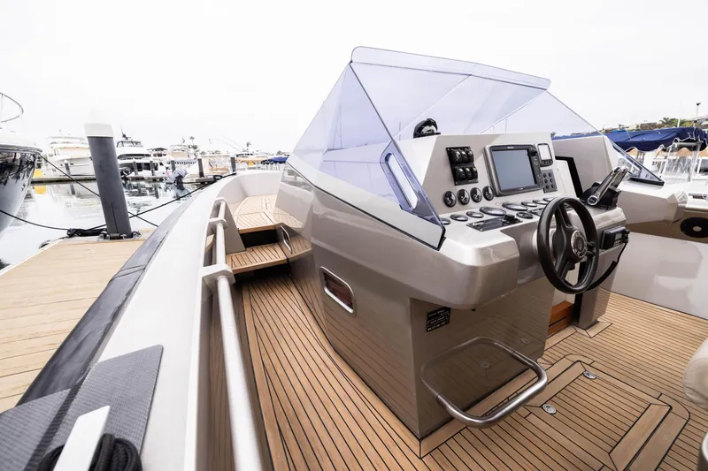 Slide: The Image of 2005 Wally Yachts Tender Express with sleek helm and modern controls at marina. - 6