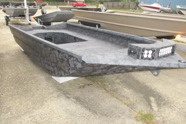Slide: The Image of 2026 Reaper Boats 656-1689 model, gray camouflage design, parked on a concrete surface. - 3