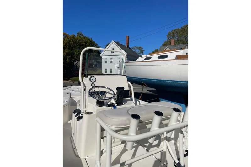 Slide: The Image of 2021 Sea Born FX21 Bay boat with steering console and rod holders, docked outdoors. - 3
