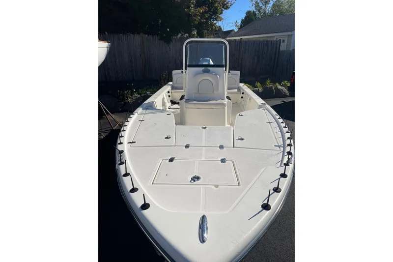 Slide: The Image of 2021 Sea Born FX21 Bay boat, white deck, sleek design, parked outdoors. - 5