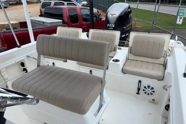 Slide: The Image of 2011 NauticStar 210 Coastal boat interior with beige seating and Yamaha 115 engine. - 13