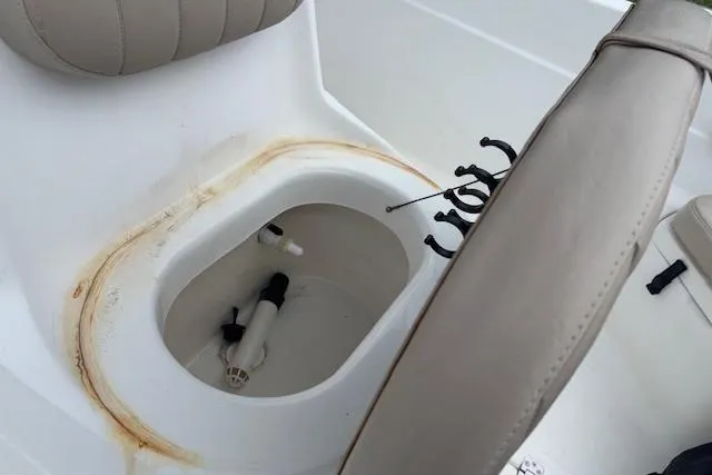 Slide: The Image of 2011 NauticStar 210 Coastal boat interior with storage compartment and seating. - 14